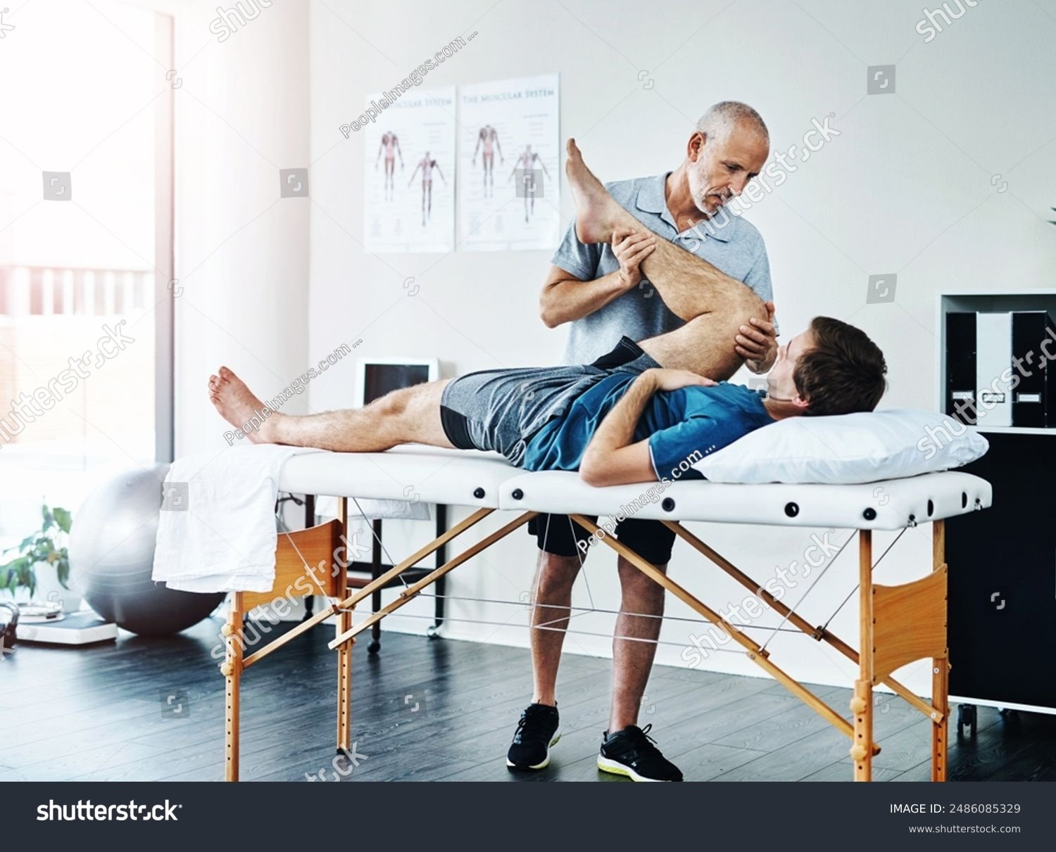 stock-photo-male-people-knee-injury-and-physiotherapist-working-in-consulting-room-rehabilitation-with-2486085329